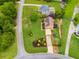 Aerial view of a home with a well-maintained lawn, mature trees, and a long driveway at 638 Oberlochen Way, Douglasville, GA 30134