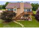 Beautiful backyard with a deck, lower patio, stepping stone pathway, and mature trees providing a serene setting at 638 Oberlochen Way, Douglasville, GA 30134