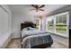 Cozy bedroom with a large bed, windows and view to backyard at 638 Oberlochen Way, Douglasville, GA 30134