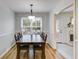 Formal dining room with hardwood floors, pendant lighting, and wainscoting at 638 Oberlochen Way, Douglasville, GA 30134