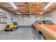 A spacious three car garage with one side setup with a car and another with a lawnmower at 638 Oberlochen Way, Douglasville, GA 30134