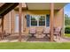 Charming patio space with seating, perfect for outdoor relaxation and entertaining with a door entering the house at 638 Oberlochen Way, Douglasville, GA 30134