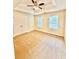 Spacious bedroom with neutral carpet, tray ceiling, and ceiling fan at 759 Hennepin Ter, Mcdonough, GA 30253