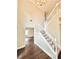 Bright entryway featuring a staircase with white railings, hardwood floors and a chandelier at 759 Hennepin Ter, Mcdonough, GA 30253