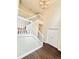 Bright interior showcasing a staircase with white railings, hardwood floors, and neutral-toned walls at 759 Hennepin Ter, Mcdonough, GA 30253