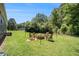 Landscaped backyard featuring fire pit with Adirondack chairs at 130 Driver St, Temple, GA 30179