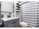 Bathroom featuring modern vanity, toilet, and shower with striped curtain at 130 Driver St, Temple, GA 30179