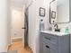Bathroom vanity with modern faucet, mirror and open door to shower at 130 Driver St, Temple, GA 30179
