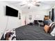 Spacious bedroom with a ceiling fan, featuring a large bed and a mounted TV at 130 Driver St, Temple, GA 30179