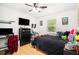 Bedroom with dark comforter, TV, desk, and ceiling fan for a comfortable space at 130 Driver St, Temple, GA 30179
