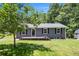 Charming single-story home with a well-maintained lawn and a cozy front porch at 130 Driver St, Temple, GA 30179