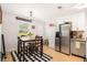 Bright kitchen with stainless steel appliances, white cabinetry and dining table with four chairs at 130 Driver St, Temple, GA 30179