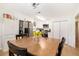 Bright kitchen with stainless steel appliances, white cabinetry and a large table with chairs at 130 Driver St, Temple, GA 30179