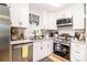 Well-lit kitchen featuring white cabinets, granite countertops and stainless steel appliances at 130 Driver St, Temple, GA 30179