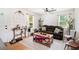 Bright living room featuring a comfortable brown sofa, decorative pillows, and ample natural light at 130 Driver St, Temple, GA 30179