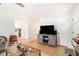 Open living room with hardwood floors, a large TV and a view into the kitchen area at 130 Driver St, Temple, GA 30179