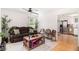 Cozy living room showcasing a brown sofa and hardwood floors that leads to the kitchen at 130 Driver St, Temple, GA 30179