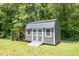 A well-maintained gray storage shed featuring double doors at 130 Driver St, Temple, GA 30179