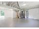 Unfinished basement with painted floor and walls, exposed beams, and access to backyard at 1349 Heather Cir, Riverdale, GA 30296