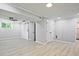 Finished basement area featuring a ceiling fan, barn door, and closet with bi-fold doors at 1349 Heather Cir, Riverdale, GA 30296