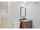 Powder room featuring dark wood vanity with modern mirror, sink and fixtures at 1349 Heather Cir, Riverdale, GA 30296