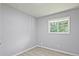 Bedroom featuring wood-look floors, gray walls, and natural light from a window at 1349 Heather Cir, Riverdale, GA 30296