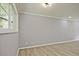Bright bedroom featuring wood-look floors and a window with green outdoor view at 1349 Heather Cir, Riverdale, GA 30296