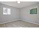 Bright bedroom with wood-look floors and two windows, offering plenty of natural light at 1349 Heather Cir, Riverdale, GA 30296