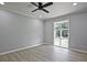 Bedroom with light gray walls, updated floors, ceiling fan and natural light from the single window at 1349 Heather Cir, Riverdale, GA 30296