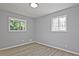 Bright bedroom with wood-look floors and two windows, offering plenty of natural light at 1349 Heather Cir, Riverdale, GA 30296