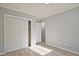 Bedroom featuring wood-look floors, closet, and white doors that enhance the space at 1349 Heather Cir, Riverdale, GA 30296