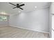 Spacious bedroom with light gray walls, updated floors, ceiling fan and natural light from the two windows at 1349 Heather Cir, Riverdale, GA 30296