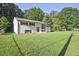 Exterior of a single-story home with painted white brick, brown shutters, red door and a well-manicured lawn at 1349 Heather Cir, Riverdale, GA 30296