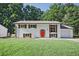 Charming, renovated single-story home with white painted brick, red door, brown shutters and a well-manicured lawn at 1349 Heather Cir, Riverdale, GA 30296
