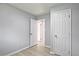 Hallway with wood-look floors and neutral paint, brightened by an open door to an adjacent room at 1349 Heather Cir, Riverdale, GA 30296