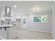 Open kitchen design with white cabinets, gray subway tile backsplash, stainless hood and modern light fixture at 1349 Heather Cir, Riverdale, GA 30296