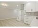 Modern kitchen featuring white cabinets, stainless hood, gray backsplash and gorgeous countertops at 1349 Heather Cir, Riverdale, GA 30296