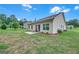 A well-maintained backyard with a lush lawn, a patio, and manicured landscaping, perfect for outdoor relaxation at 1431 Beckett Dr, Hampton, GA 30228