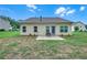 Home's backyard featuring a patio and a well-maintained lawn at 1431 Beckett Dr, Hampton, GA 30228