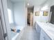 Serene bathroom with a soaking tub, white vanity, and modern fixtures at 1431 Beckett Dr, Hampton, GA 30228