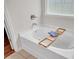 Relaxing soaking tub features a stylish wooden tray for the ultimate in-home spa experience at 1431 Beckett Dr, Hampton, GA 30228