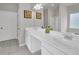 Elegant bathroom with double vanity, marble countertops, and a tiled floor at 1431 Beckett Dr, Hampton, GA 30228