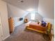 Cozy bedroom with sloped ceilings, carpet flooring and a window for natural light at 1431 Beckett Dr, Hampton, GA 30228