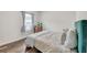 Cozy bedroom featuring hardwood floors, a comfortable bed, and soft, natural light from the window at 1431 Beckett Dr, Hampton, GA 30228