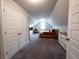 An open bedroom with gray carpet and angled ceilings featuring a yellow bed and two closets at 1431 Beckett Dr, Hampton, GA 30228