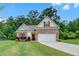 Charming single-Gathering home with manicured lawn, brick accents, and a two-car garage at 1431 Beckett Dr, Hampton, GA 30228