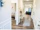 Bright hallway with wood floors, white wainscoting, and views into the living room at 1431 Beckett Dr, Hampton, GA 30228