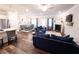 Bright, open living area with a fireplace, dark floors, adjacent to the dining and kitchen at 1431 Beckett Dr, Hampton, GA 30228