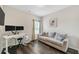 Functional living space features a contemporary sofa, desk, and dual monitor setup for work from home at 1431 Beckett Dr, Hampton, GA 30228