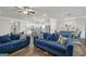 Spacious living room showcasing blue sofas, dark floors, and an open concept design at 1431 Beckett Dr, Hampton, GA 30228
